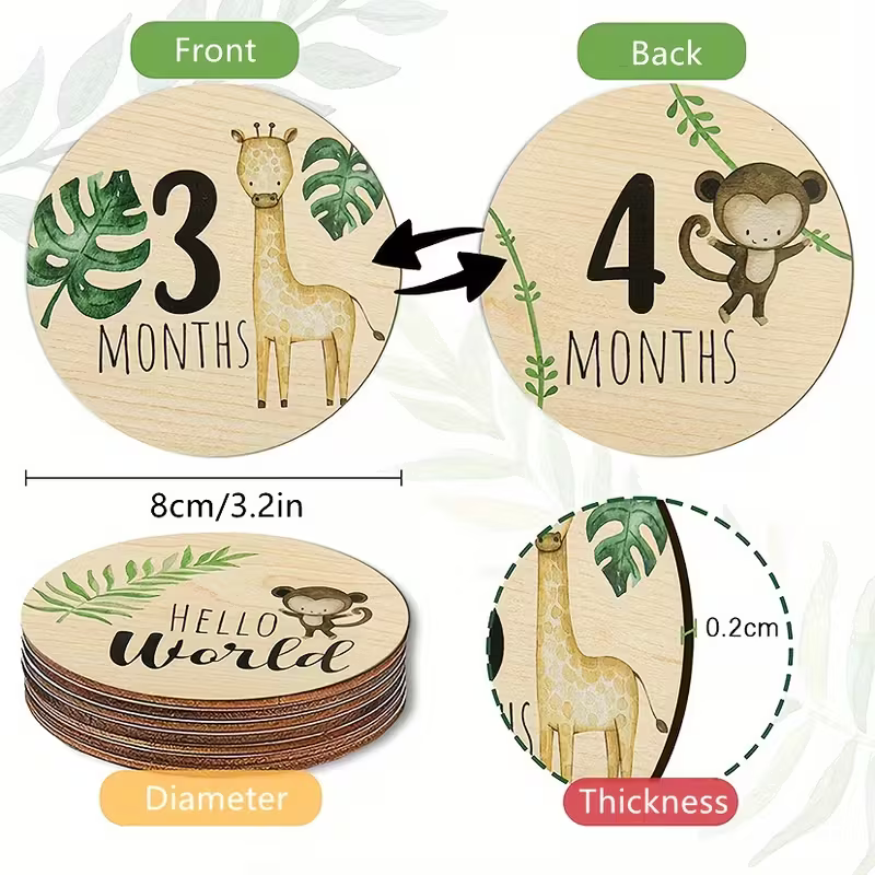 A product infographic showing round wooden baby milestone coasters with front and back designs, dimensions, and thickness. The coasters are light natural wood with printed green leaves, a giraffe, and a monkey, labeled '3 MONTHS' and '4 MONTHS', with text indicating 8cm/3.
